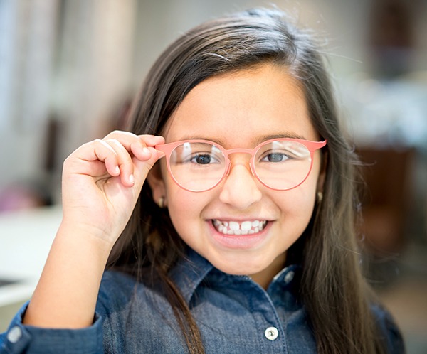 Little Girl trying glasses at the optician