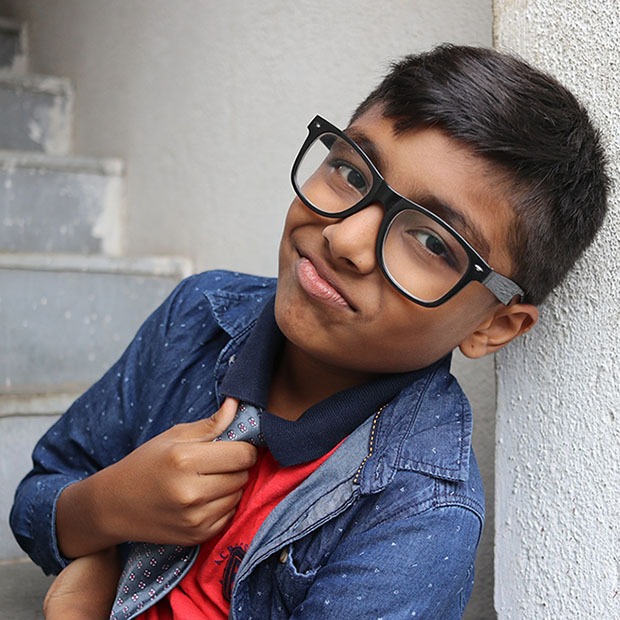 Young boy with a tie and black glasses