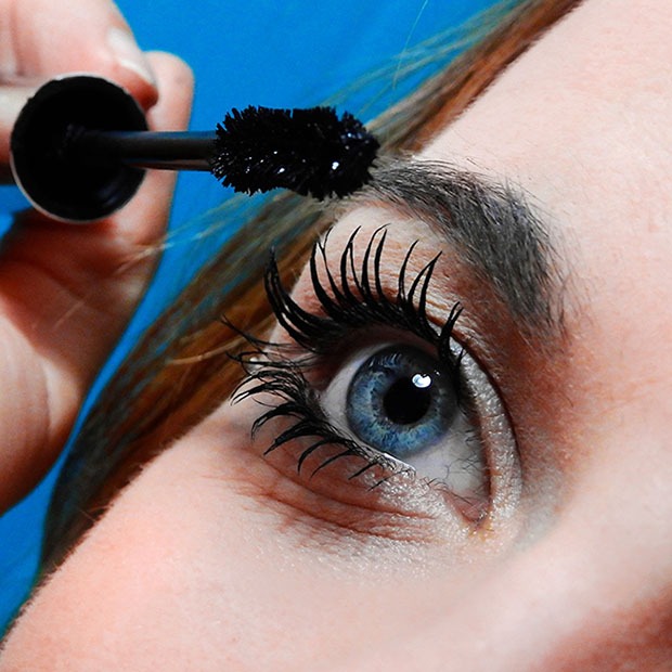 Closeup shot of woman applying mascara