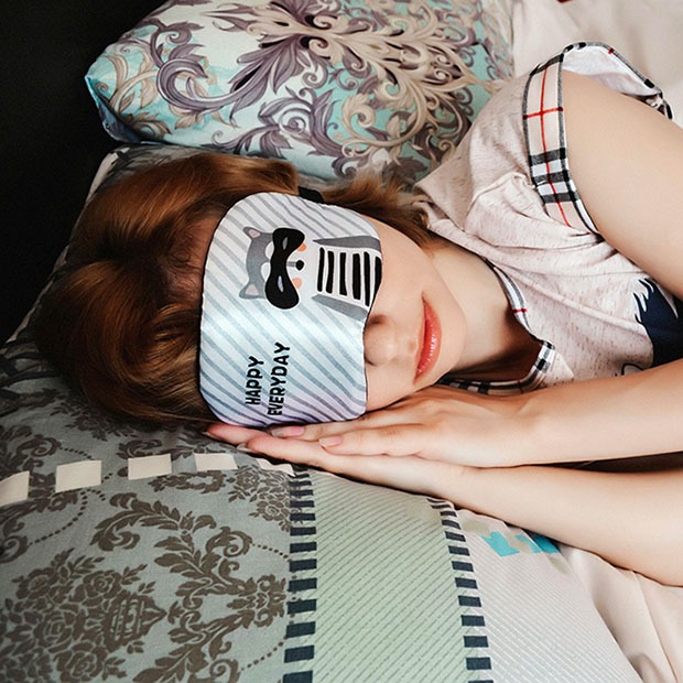 Young woman sleeping with eye mask over her eyes