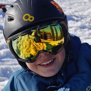 Closeup shot of person in snow gear with their eyes covered